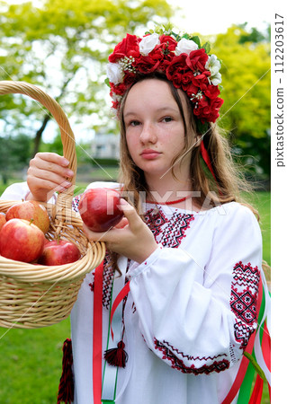 Little Ukrainian girl with ducklings in a basket in the garden Little Ukrainian girl with ducklings in a basket in the garden 112203617