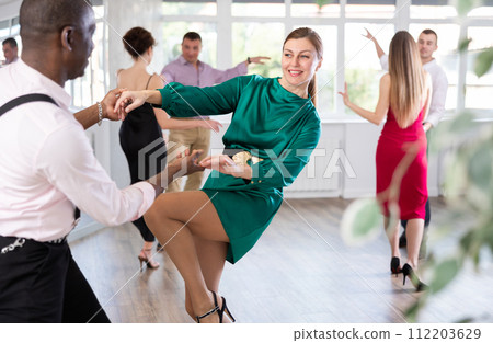 Man and woman practicing swing dance in dancing studio Man and woman practicing swing dance in dancing studio 112203629