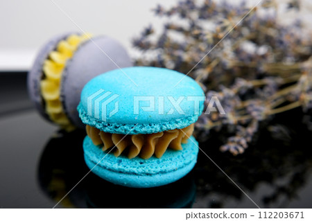 sweet lavender macaroons French with flowers lavender copy space Monochrome gray macaron or macaroon on concrete background almond cookies with different fillings chocolate, caramel Selective focus sweet lavender macaroons French with flowers lavender copy space Monochrome gray macaron or macaroon on concrete background almond cookies with different fillings chocolate, caramel Selective focus 112203671