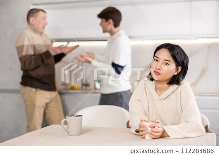 Young woman sad during family quarrel Young woman sad during family quarrel 112203686