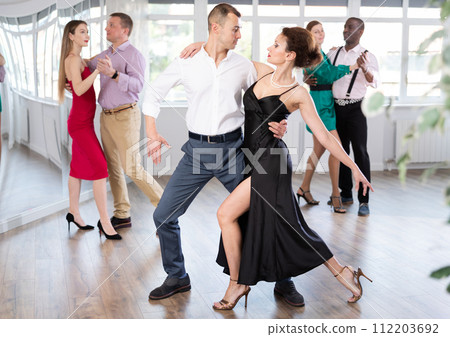 Woman and young man practicing waltz in dancing studio 112203692