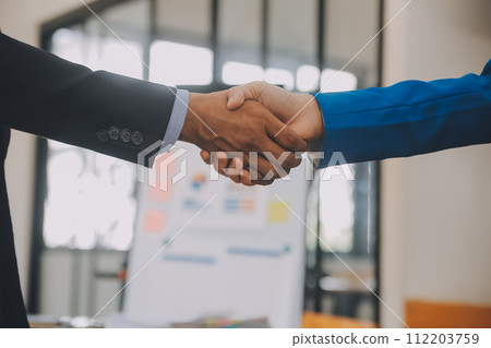 Business handshake for teamwork of business merger and acquisition,successful negotiate,hand shake,two businessman shake hand with partner to celebration partnership and business deal concept 112203759