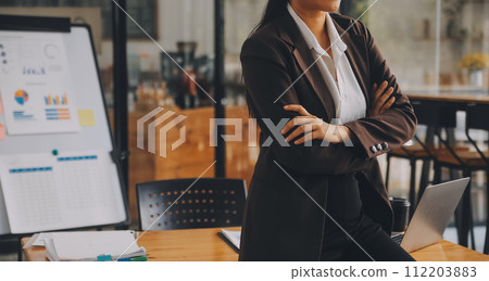 Asian Businesswoman working on laptop at the office with documents on his desk, doing planning analyzing the financial report, business plan investment, finance analysis concept Asian Businesswoman working on laptop at the office with documents on his desk, doing planning analyzing the financial report, business plan investment, finance analysis concept 112203883