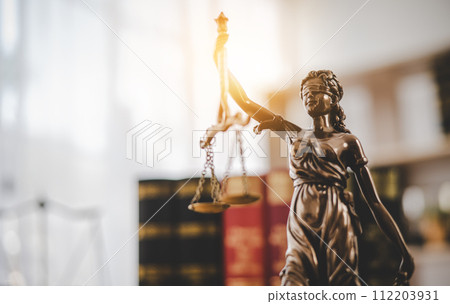 Lady Justice Holding Scales of Law in a Courtroom - Symbolizing Equality, Fairness, and Legal Proceedings 112203931
