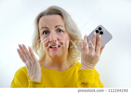 woman with phone in hands disappointed she raised eyebrows wide open eyes slight smile good looks upset surprised that this is how it could be price increase end of registration have time to apply woman with phone in hands disappointed she raised eyebrows wide open eyes slight smile good looks upset surprised that this is how it could be price increase end of registration have time to apply 112204298
