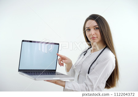 banner girl with laptop in headphones communicates online conference with friends waving a lot of space for text ad gadgets online courses internet social networks Web studio woman beautiful teeth 112204372