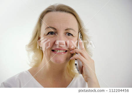 unexpected surprise woman talking on the phone unpleasant smile open eyes wide something went wrong strange news gossip 112204456
