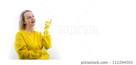 banner place for advertising text cleaning cleaning company housewife blonde girl putting hand on chest, pointing right in pink t-shirt and yellow jacket and looking surprised. front view.  112204503