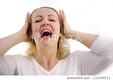 I do not want to hear it Closeup portrait of upset, tired woman screaming loud close eyes embracing her had by hands isolated on gray background 112204511