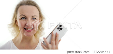 banner woman smiling happily holding phone in hands joy shopping order chatting conversation fun waiting meeting sincere smile blonde hair middle age place for text advertising order online shopping 112204547