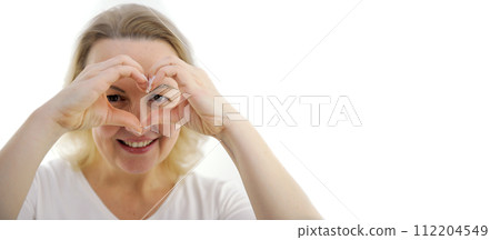 Banner portrait of beautiful Asian woman on white shirt smile and hand gesture in heart shape showing love, support to medical staffs, charity, donation campaign. World heart day, Woman Health concept 112204549
