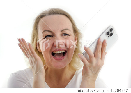 great happiness success joy close-up face of a woman laughing sincerely open her mouth looks to the side holds the phone in her hands raised her hands up on a white background great happiness success joy close-up face of a woman laughing sincerely open her mouth looks to the side holds the phone in her hands raised her hands up on a white background 112204557