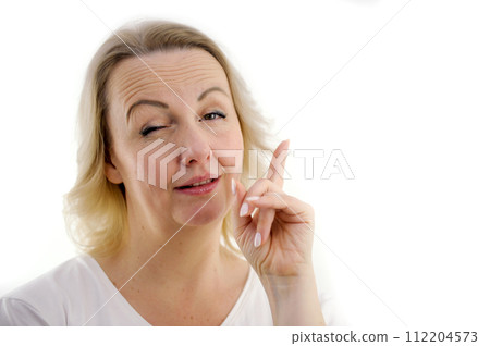 Attention listen to me. Close up portrait woman wagging her finger holding glasses skeptically isolated white grey wall background. Negative human emotion face expression body language attitude 112204573