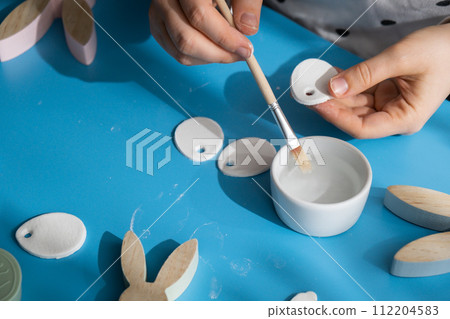 Creator is using white air dry clay for making decor to EASTER holiday. Creating hobby recreation activity that involves fingers. DIY crafting Creator is using white air dry clay for making decor to EASTER holiday. Creating hobby recreation activity that involves fingers. DIY crafting 112204583