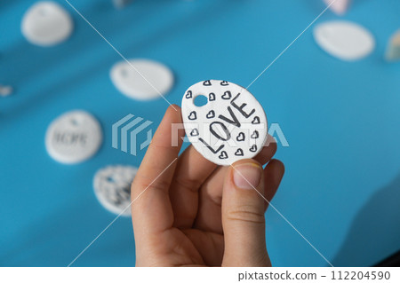 Master class writing word LOVE on EASTER egg Children air dry clay activity handicraft idea. DIY process step by step instruction. Preparing for Easter holiday decorating. Modern organic design 112204590