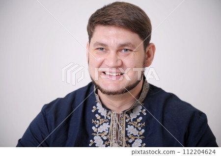 strength courage confidence Ukrainian man smiling in Ukrainian clothes. National clothes embroidered by hand or on a typewriter. Patriot outfit . High quality photo strength courage confidence Ukrainian man smiling in Ukrainian clothes. National clothes embroidered by hand or on a typewriter. Patriot outfit . High quality photo 112204624