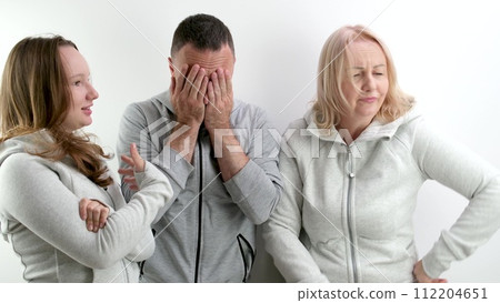 family quarrel women against men two girls mother and daughter scold father wave hands man covers his face in horror bad relationship showdown family quarrel women against men two girls mother and daughter scold father wave hands man covers his face in horror bad relationship showdown 112204651