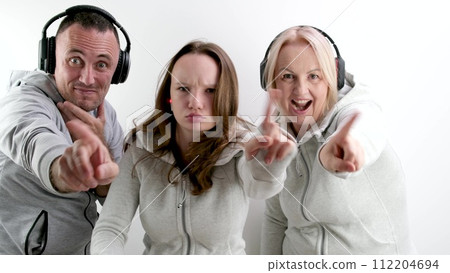 man and two women teenage girl doing negative Swing with index finger No don't do it look into the frame extending hand with finger forward headphones tracksuits white background man and two women teenage girl doing negative Swing with index finger No don't do it look into the frame extending hand with finger forward headphones tracksuits white background 112204694