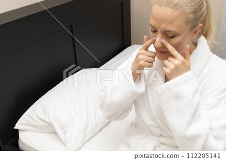 White Woman Applies Nasal Strip on Nose Before Going To Bed, Sitting on Bed. Stop Drug-free, Snoring, Sleeping Apnea Solution. Copy Space. Adhesive Bandage For Better Healthy Breathing. Horizontal. White Woman Applies Nasal Strip on Nose Before Going To Bed, Sitting on Bed. Stop Drug-free, Snoring, Sleeping Apnea Solution. Copy Space. Adhesive Bandage For Better Healthy Breathing. Horizontal. 112205141
