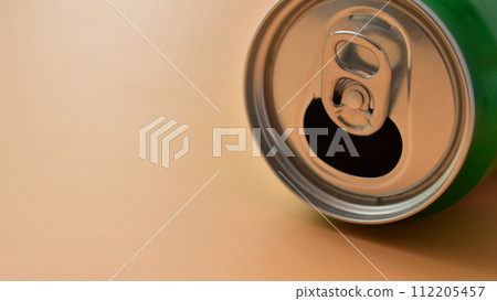 aluminum green drink cans on orange background, open cold fresh beverage 112205457