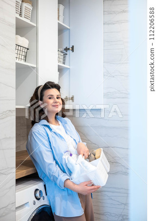 Smiling housewife female white bathroom laundry general cleaning detergent storage organizing Smiling housewife female white bathroom laundry general cleaning detergent storage organizing 112206588