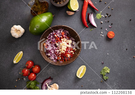 Cooking traditional salsa - sliced chopped ingredients in a wooden bowl Cooking traditional salsa - sliced chopped ingredients in a wooden bowl 112208138