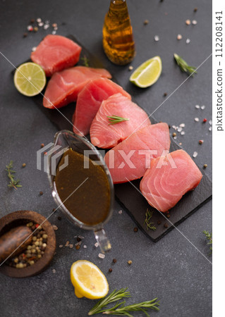 Pieces of Fresh tuna Fish fillet and soy sauce marinade in a glass bowl 112208141