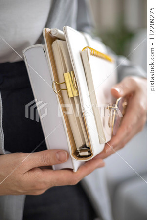 Business woman psychologist manager marketologist hands stack paper notepad and eyeglasses closeup 112209275