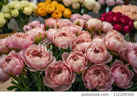 Multicolored pions in a flower shop - fresh supply of cut flowers for spring holidays, floral shop. AI generated 112209300