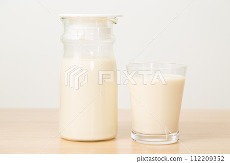 玻璃杯和水罐中的豆奶 玻璃杯和水罐中的豆奶 112209352