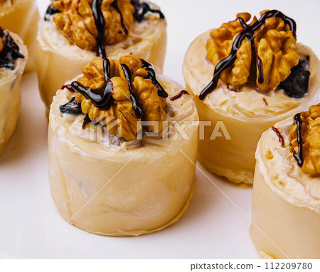 sweet pancake rolls with walnuts 112209780
