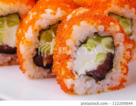 Macro shot of california maki sushi rolls with rice 112209844
