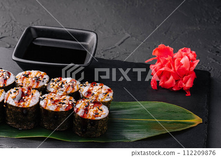 Traditional fresh japanese sushi futomaki on black stone 112209876