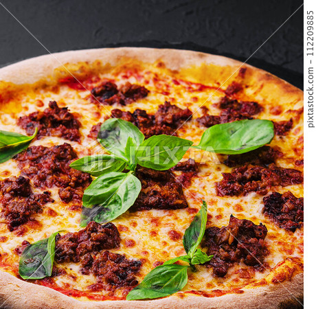 Pizza with minced meat and mozzarella on a stone board 112209885