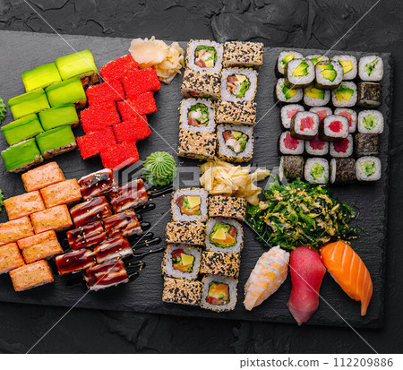 Large sushi set, shot from the top on a black background Large sushi set, shot from the top on a black background 112209886