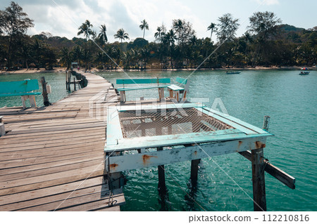 Wooden pier by the beach and clear blue water on the island 112210816