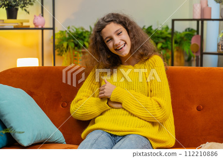 Child girl laughing out loud after hearing ridiculous anecdote, funny joke, feeling carefree amused 112210886