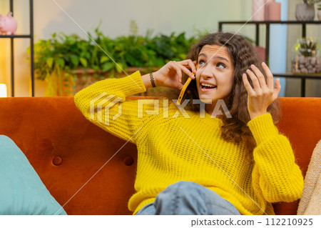Happy surprised child girl having pleasant conversation phone call good news enjoying talking gossip Happy surprised child girl having pleasant conversation phone call good news enjoying talking gossip 112210925
