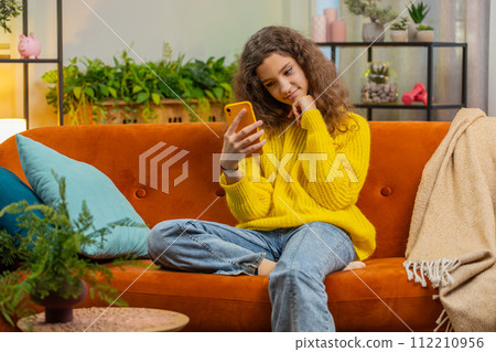 Young child kid girl texting share messages content on smartphone social media applications online Young child kid girl texting share messages content on smartphone social media applications online 112210956