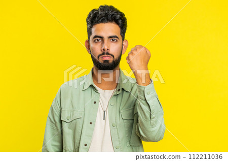 Aggressive angry Indian man trying to fight at camera, shaking fist, boxing, punishment, threaten 112211036