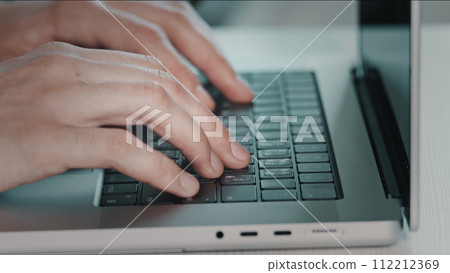 Man hands typing on laptop close up. Online project, report research at desk. Planning, business, freelancer student using laptop studying online working from home in internet. Blue toning side view 112212369