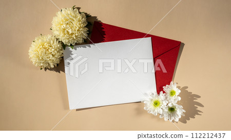 Composition with empty paper note and envelope beautiful spring white flowers on beige background. Mockup card invitation greeting card postcard copy space template 112212437