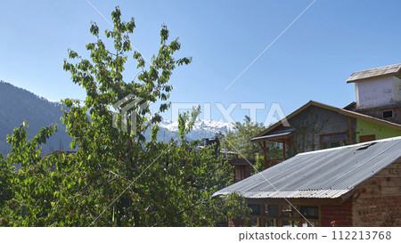 A vast landscape with clear skies, clouds, and snowy mountains. 112213768