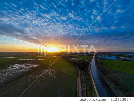 Dramatic Sunset Aerial View over Country Road and Fields Dramatic Sunset Aerial View over Country Road and Fields 112213934