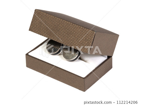Old silver cufflinks in a box, on white background 112214206