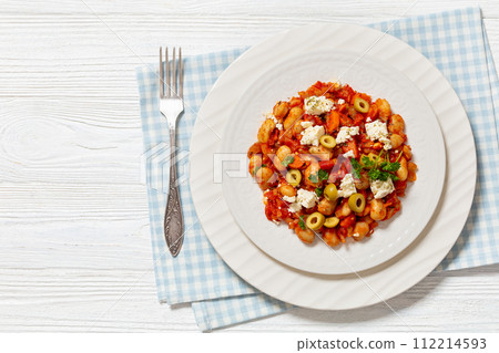 greek giant baked beans with feta, olives on plate 112214593