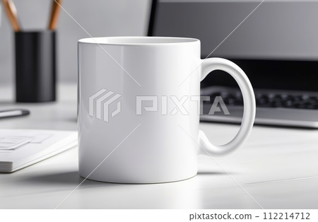 Mug Mock-Up. Blank white 11 oz ceramic cup is on a desk, office interior blurred background. Great for overlaying your custom quotes and designs for selling mugs. Notebooks on wooden table indoors. Mug Mock-Up. Blank white 11 oz ceramic cup is on a desk, office interior blurred background. Great for overlaying your custom quotes and designs for selling mugs. Notebooks on wooden table indoors. 112214712