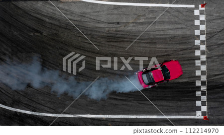Aerial top view car drifting diffusion race drift car with lots of smoke from burning tires on speed track, Professional driver drifting car with lots of white smoke . Aerial top view car drifting diffusion race drift car with lots of smoke from burning tires on speed track, Professional driver drifting car with lots of white smoke . 112214970
