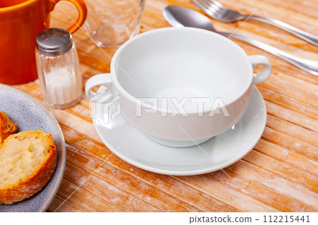 Bowl served on table with cutlery Bowl served on table with cutlery 112215441