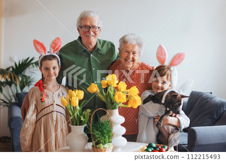 Easter portriat of grandparents with grandchildren before traditional easter lunch. Recreating family traditions and customs. Happy easter. 112215493